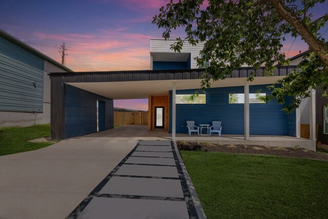 5809 Toscana Ave, Austin, TX 78724 - contemporary home with a yard, an attached carport, and concrete driveway