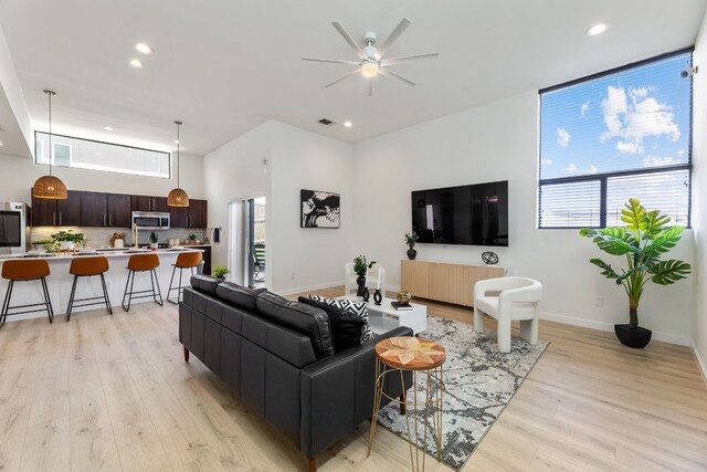 5809 Toscana Ave, Austin, TX 78724 - living area with light wood finished floors, plenty of natural light, ceiling fan, recessed lighting, and baseboards