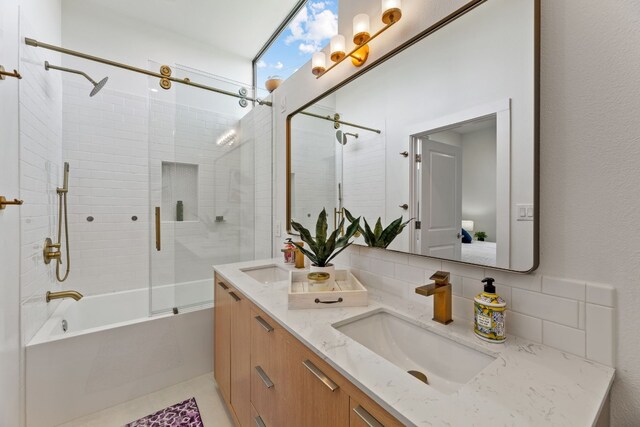 5809 Toscana Ave, Austin, TX 78724 - full bathroom featuring bath / shower combo with glass door, tasteful backsplash, double vanity, and ensuite bath