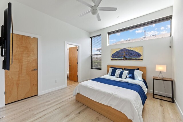 5809 Toscana Ave, Austin, TX 78724 - bedroom with light wood-type flooring, baseboards, ensuite bath, and a ceiling fan
