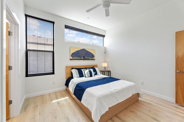 5809 Toscana Ave, Austin, TX 78724 - bedroom with light wood-style floors, baseboards, and a ceiling fan
