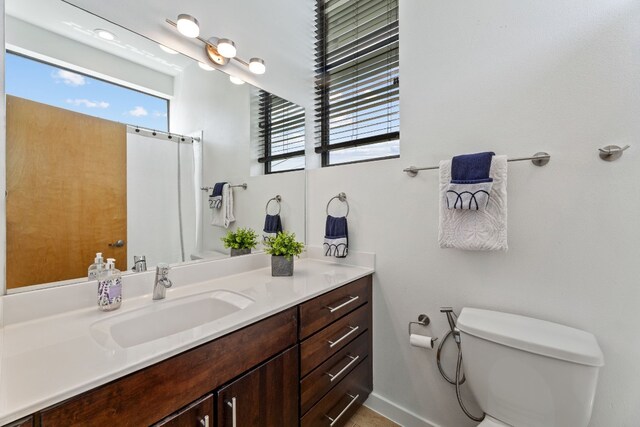 5809 Toscana Ave, Austin, TX 78724 - full bath featuring toilet, vanity, a shower with shower curtain, and baseboards