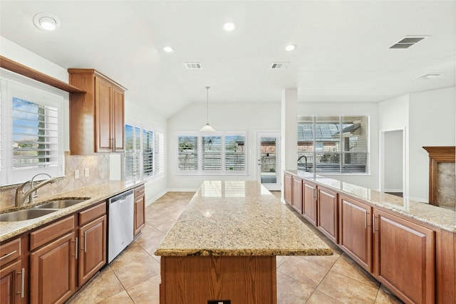 kitchen with dishwasher, a sink, a kitchen island, and a healthy amount of sunlight