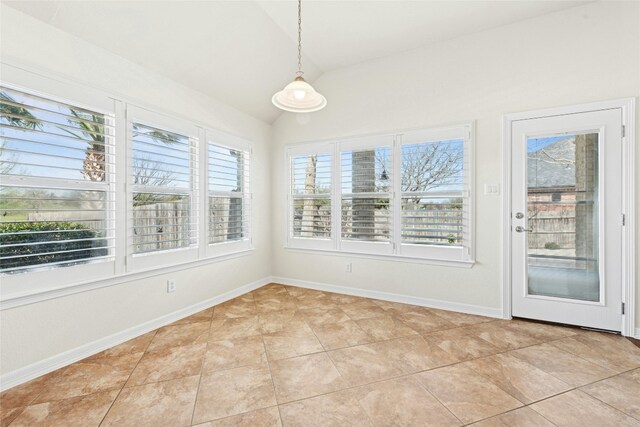 20700 Windmill Ridge St, Pflugerville, TX 78660 - unfurnished dining area with vaulted ceiling, light tile patterned floors, and baseboards