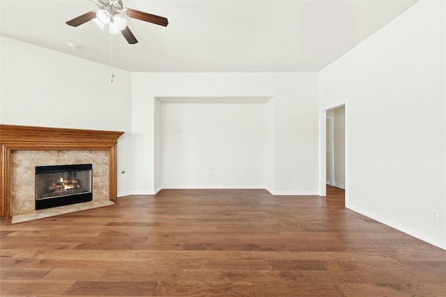 20700 Windmill Ridge St, Pflugerville, TX 78660 - unfurnished living room featuring a ceiling fan, a premium fireplace, wood finished floors, and baseboards