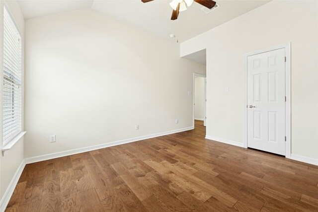 20700 Windmill Ridge St, Pflugerville, TX 78660 - unfurnished bedroom featuring wood finished floors, baseboards, lofted ceiling, and a ceiling fan
