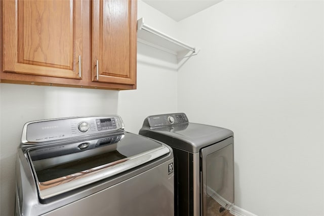 20700 Windmill Ridge St, Pflugerville, TX 78660 - washroom with cabinet space, washer and dryer, and baseboards