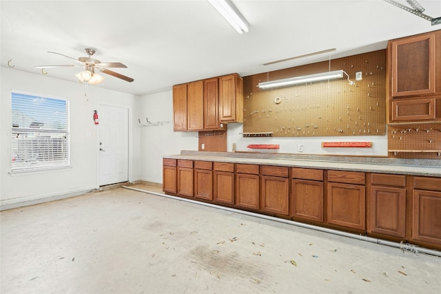 20700 Windmill Ridge St, Pflugerville, TX 78660 - kitchen featuring brown cabinetry, a ceiling fan, light countertops, and concrete floors
