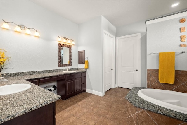 362 Wellington Dr, Austin, TX 78737 - bathroom featuring double vanity, baseboards, a relaxing tiled tub, and a sink