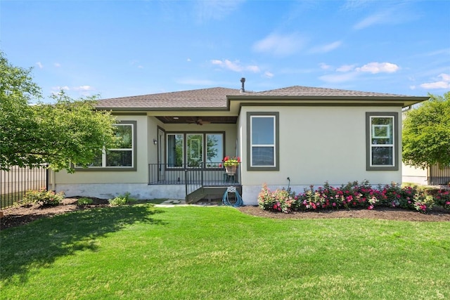 362 Wellington Dr, Austin, TX 78737 - back of house featuring covered porch, ceiling fan, a lawn, fence, and stucco siding