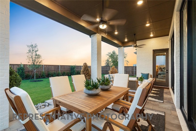 367 Muddy Crk, Kyle, TX 78640 - patio terrace at dusk with outdoor dining space, a ceiling fan, and a patio