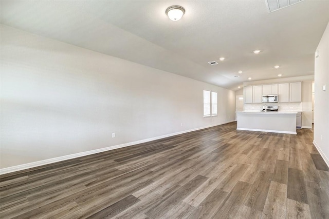 152 Greenway Ln, Georgetown, TX 78628 - unfurnished living room with wood finished floors and recessed lighting