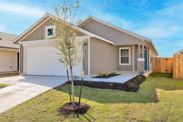 152 Greenway Ln, Georgetown, TX 78628 - view of front of house featuring an attached garage, driveway, and board and batten siding