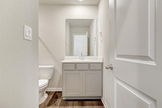 152 Greenway Ln, Georgetown, TX 78628 - bathroom with vanity, wood finished floors, and a textured wall