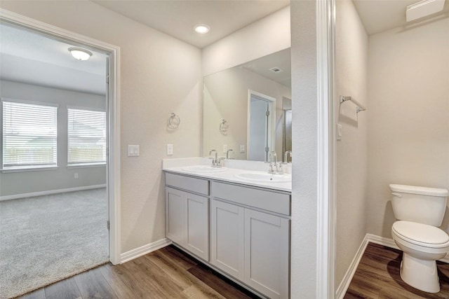 152 Greenway Ln, Georgetown, TX 78628 - bathroom featuring double vanity and wood finished floors