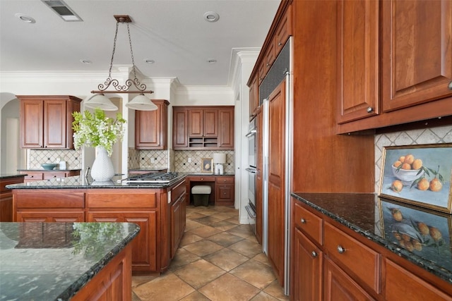 kitchen featuring brown cabinets, visible vents, ornamental molding, and decorative backsplash