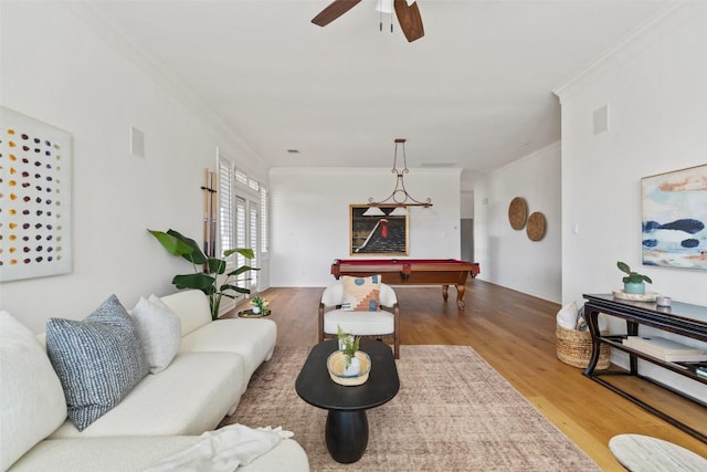 living room with wood finished floors, visible vents, a ceiling fan, ornamental molding, and pool table
