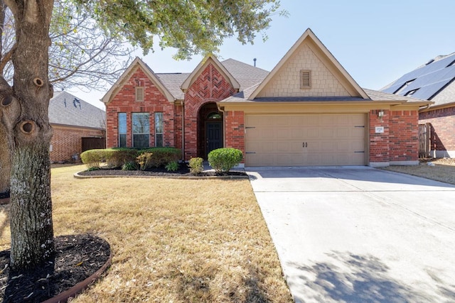 2532 Santa Barbara Loop, Round Rock, TX 78665 - view of front of property featuring brick siding, an attached garage, a front yard, driveway, and a shingled roof