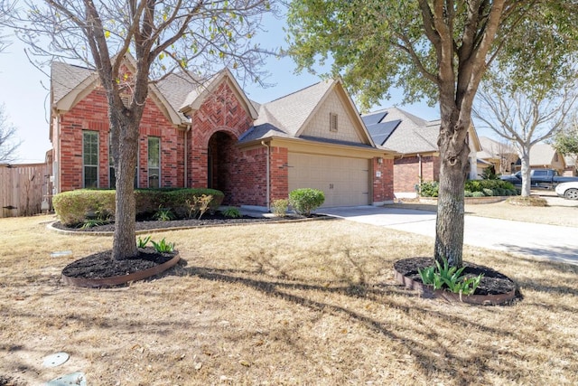 2532 Santa Barbara Loop, Round Rock, TX 78665 - traditional-style house with brick siding, driveway, a garage, and roof with shingles