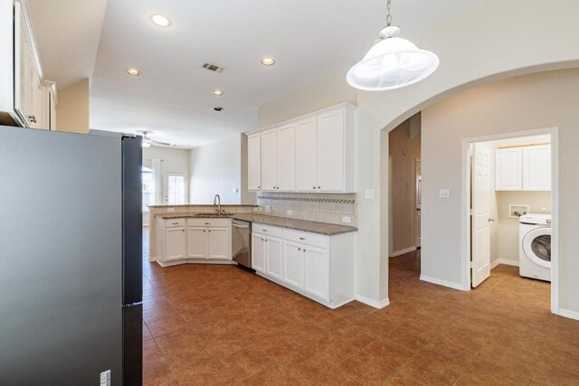 2532 Santa Barbara Loop, Round Rock, TX 78665 - kitchen featuring appliances with stainless steel finishes, washer / dryer, arched walkways, recessed lighting, and white cabinets