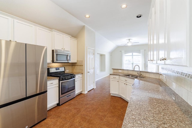 2532 Santa Barbara Loop, Round Rock, TX 78665 - kitchen with stainless steel appliances, backsplash, white cabinetry, light stone counters, and a peninsula