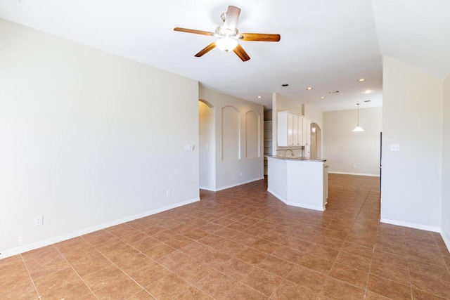2532 Santa Barbara Loop, Round Rock, TX 78665 - unfurnished living room with arched walkways, ceiling fan, and recessed lighting