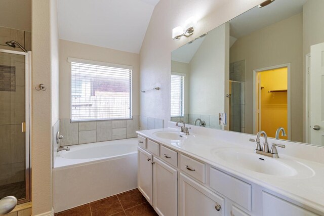 2532 Santa Barbara Loop, Round Rock, TX 78665 - bathroom featuring vaulted ceiling, a shower stall, a garden tub, double vanity, and tile patterned floors