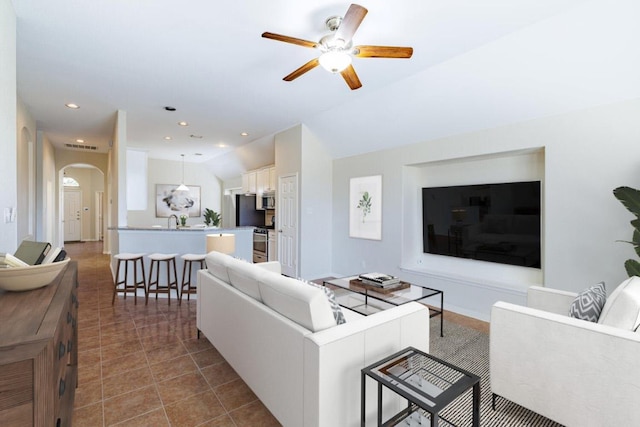 2532 Santa Barbara Loop, Round Rock, TX 78665 - living area with arched walkways, a ceiling fan, lofted ceiling, and recessed lighting