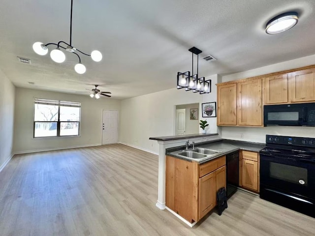 112 Flat Creek Dr, Robinson, TX 76706 - kitchen featuring black appliances, a peninsula, dark countertops, a sink, and light wood-type flooring