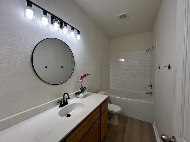 112 Flat Creek Dr, Robinson, TX 76706 - bathroom with wood finished floors, vanity, toilet, a textured wall, and shower / bath combination