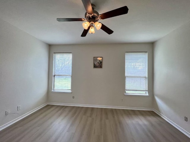 112 Flat Creek Dr, Robinson, TX 76706 - empty room featuring wood finished floors, healthy amount of natural light, and baseboards