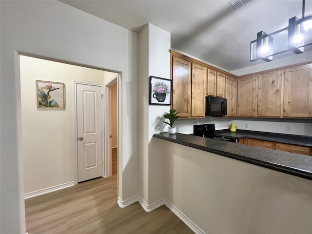 112 Flat Creek Dr, Robinson, TX 76706 - kitchen featuring black appliances, light wood-type flooring, baseboards, and dark countertops