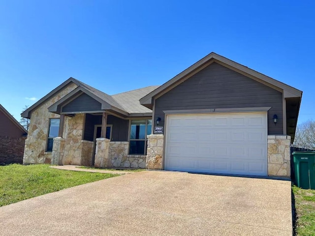 112 Flat Creek Dr, Robinson, TX 76706 - ranch-style house with stone siding, driveway, and a garage