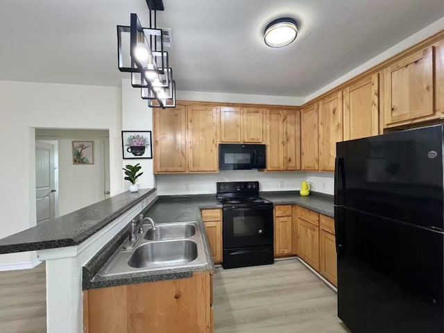 112 Flat Creek Dr, Robinson, TX 76706 - kitchen featuring black appliances, a sink, a peninsula, light wood finished floors, and dark countertops