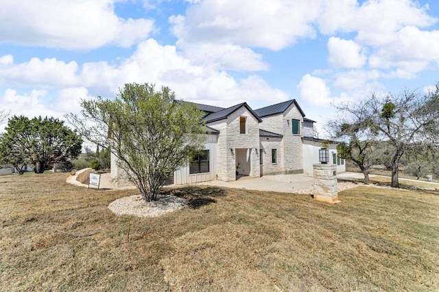 102 Mountain Home Rd, Horseshoe Bay, TX 78657 - rear view of property with a patio, roof mounted solar panels, a yard, and stone siding