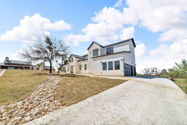 102 Mountain Home Rd, Horseshoe Bay, TX 78657 - view of front of property featuring concrete driveway, an attached garage, a front lawn, and stucco siding