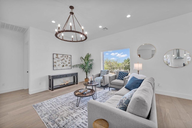 102 Mountain Home Rd, Horseshoe Bay, TX 78657 - living room featuring wood finished floors, baseboards, a chandelier, a warm lit fireplace, and recessed lighting