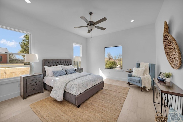 102 Mountain Home Rd, Horseshoe Bay, TX 78657 - bedroom with multiple windows, light wood finished floors, recessed lighting, and baseboards