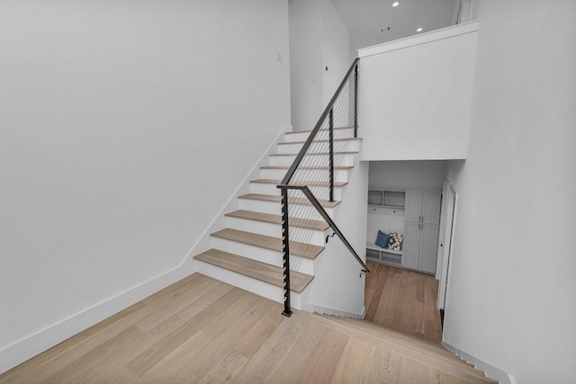102 Mountain Home Rd, Horseshoe Bay, TX 78657 - stairs with wood finished floors, baseboards, a towering ceiling, and recessed lighting