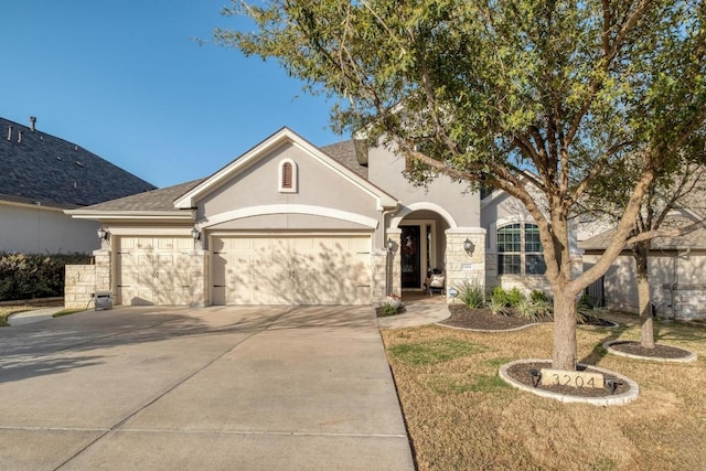 3204 Venezia Vw, Leander, TX 78641 - view of front of property with a garage, stucco siding, driveway, and a front yard