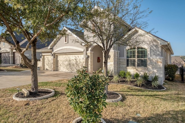 3204 Venezia Vw, Leander, TX 78641 - view of front of home featuring an attached garage, stucco siding, driveway, a front yard, and stone siding
