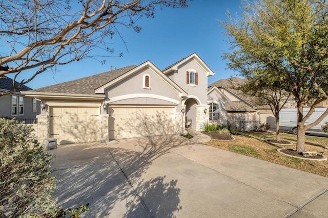 3204 Venezia Vw, Leander, TX 78641 - view of front of house featuring stucco siding, an attached garage, concrete driveway, and roof with shingles