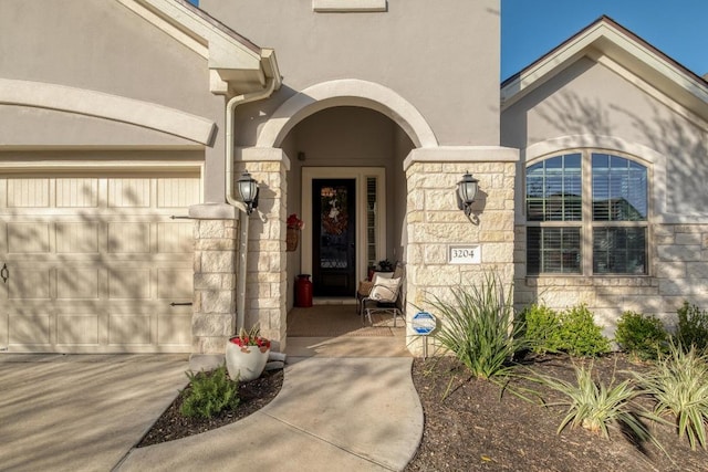 3204 Venezia Vw, Leander, TX 78641 - view of exterior entry with stucco siding, stone siding, concrete driveway, and an attached garage