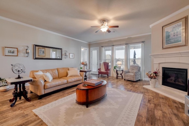 3204 Venezia Vw, Leander, TX 78641 - living room with ceiling fan, ornamental molding, wood-type flooring, and a glass covered fireplace