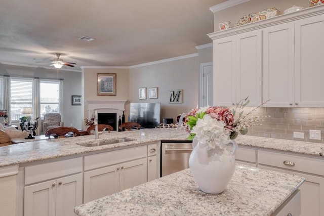 3204 Venezia Vw, Leander, TX 78641 - kitchen with open floor plan, stainless steel dishwasher, a ceiling fan, a fireplace, and crown molding
