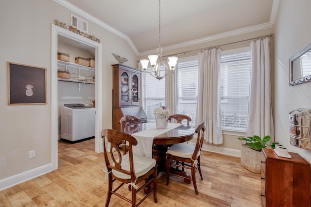3204 Venezia Vw, Leander, TX 78641 - dining room with ornamental molding, a chandelier, light wood-type flooring, washer and clothes dryer, and vaulted ceiling