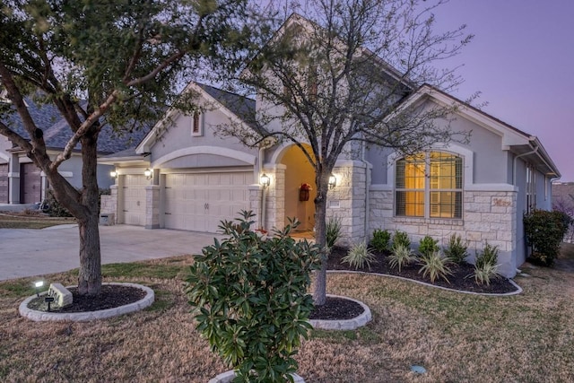 3204 Venezia Vw, Leander, TX 78641 - view of front of home featuring stone siding, a garage, driveway, and stucco siding
