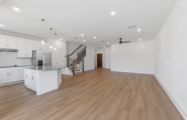 1955 Settlers Glen Dr Unit 5402, Round Rock, TX 78665 - kitchen featuring stainless steel fridge with ice dispenser, a ceiling fan, recessed lighting, white cabinetry, and a kitchen island