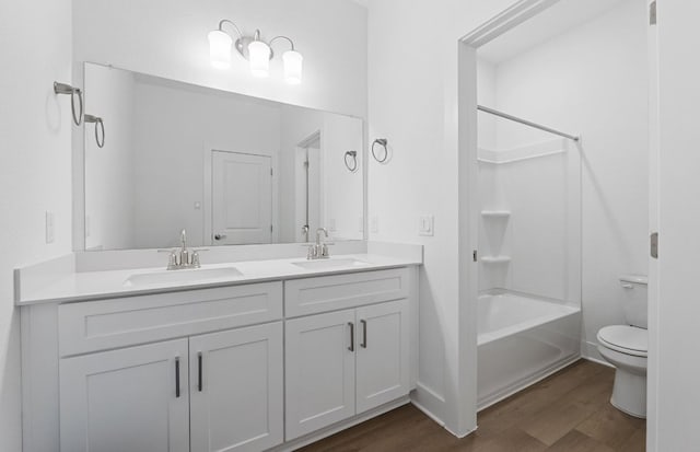 1955 Settlers Glen Dr Unit 5402, Round Rock, TX 78665 - bathroom with wood finished floors, double vanity, toilet, and  shower combination