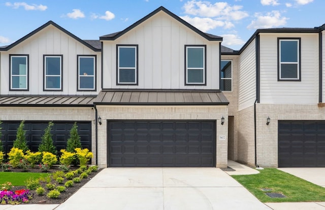 1955 Settlers Glen Dr Unit 5402, Round Rock, TX 78665 - view of front of property featuring brick siding, a standing seam roof, a garage, and board and batten siding
